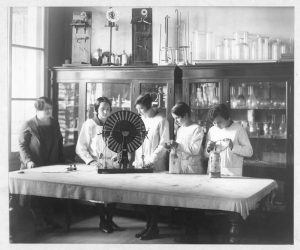 Alumnas-junto-a-profesora-trabajando-en-laboratorio-de-Física.